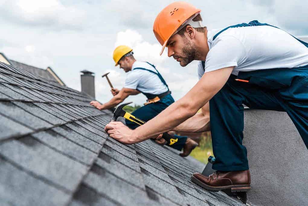 two men roofers nailing shingles; roofing industry statistics