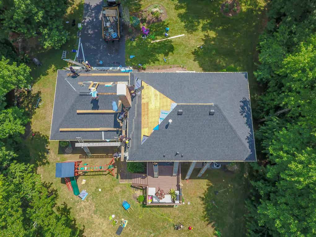 learning about roofing best practices from an aerial view of new roof installation